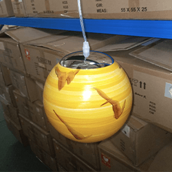 Modern marble globe pendant light with a decorative spherical shade and adjustable hanging cable.