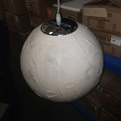 Modern moon globe pendant light with a realistic lunar surface texture and adjustable hanging cable.