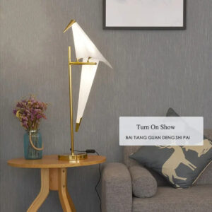Origami bird table lamp with a sculptural bird-inspired design on a premium metal stand.